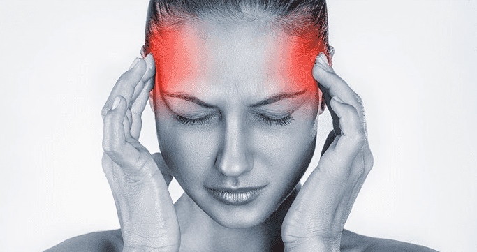 Person holding neck showing cervicogenic headache pain pattern
