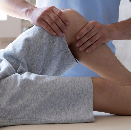 Physical therapist performing joint mobilization on a patient